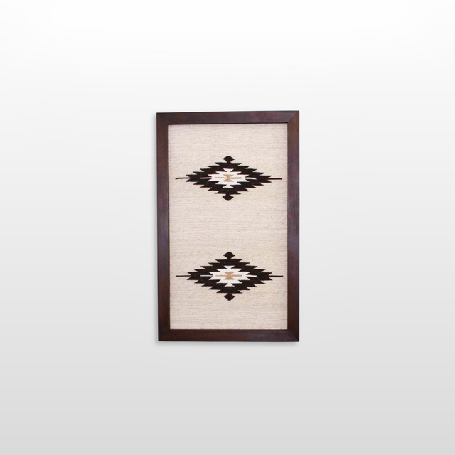 The Wool Rug Framed Wall Art showcases two black and white geometric diamond patterns on a light background, perfect for adding minimalist, eco-friendly decor to any space.