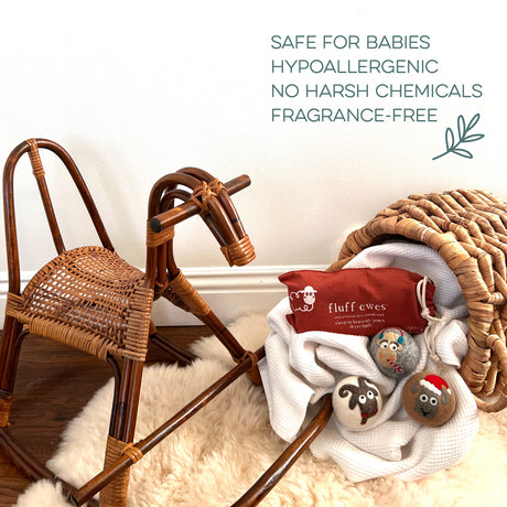Wooden rocking horse, wicker basket, white blanket, and Fluff Ewes Premium XL Dryer Balls "Sheep in Heavenly Peace" 3-pack—Holiday Limited Edition—an eco-friendly laundry essential safe for babies.