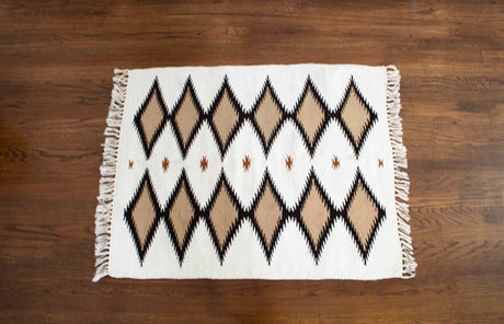 The "Handmade in Ukraine, Organic Natural 100% Sheep Wool Woven Rug Wall Hanging Decor" features black and brown diamond patterns with fringed edges, handcrafted by Ukrainian artisans from Carpathian sheep wool.