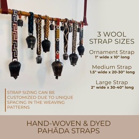 Vintage Handmade Pahāḍa Yak, Goat & Sheep’s Bells from the Himalayan Mountains of Nepal and Tibet hang on a rack, displayed in various widths and lengths; perfect as Christmas ornaments, wreath décor, or for sound baths.