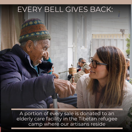 A smiling woman chats with an elderly man outdoors at a Tibetan refugee camp care facility, where Vintage Handmade Pahāḍa Yak, Goat & Sheep's Bells from Nepal and Tibet add a cheerful touch as decor or Christmas ornaments.