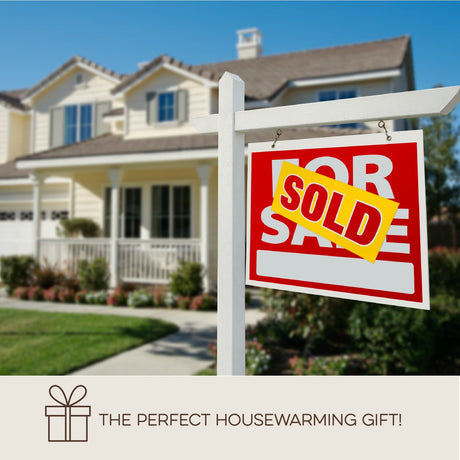 A "Sold" sign stands before a suburban home; text: "The Perfect Housewarming Gift! Get the Multi-pack Gift Bundle: 8 Packs of Fluff Ewes Dryer Balls for the Price of 6—2 Packs FREE! Save $68. Your friends will love Ewe!.
